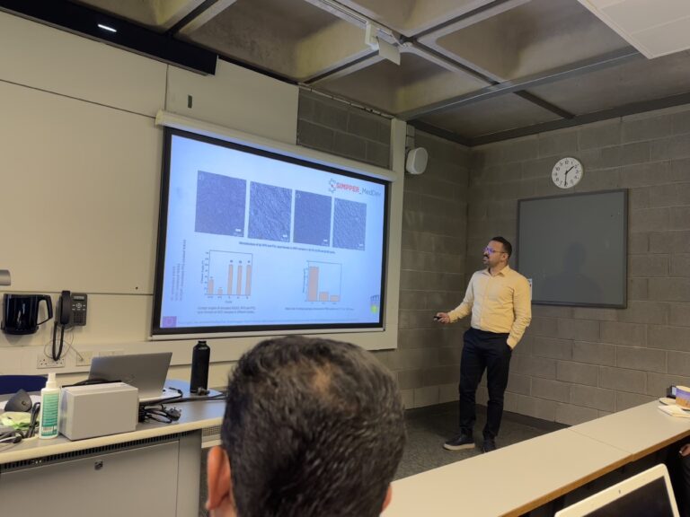 Masih presenting his research on 4th March 2024. He is pointing to the projected research slides